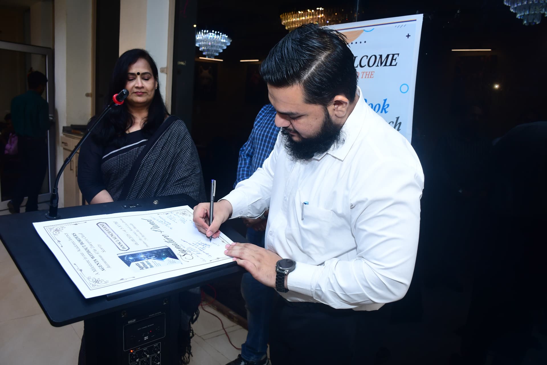 Fardeen Ahmad Khan signing the book at the launch ceremony