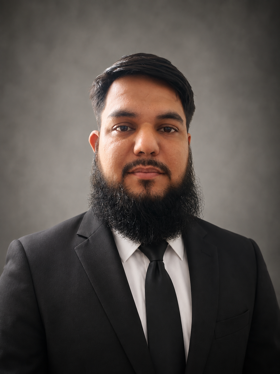 Professional headshot of Fardeen Ahmad Khan in a black suit and tie